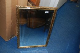 A gilt framed bevelled mirror, 19" x 29".