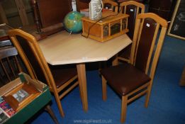 An octagonal dining table 43" diameter x 29 1/2" high and set of four chairs.