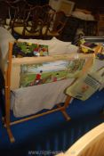 A large tapestry stand and part made tapestry plus a box of wools.