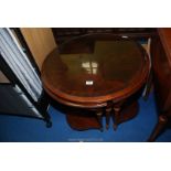 A round coffee table with glass top and four corner tables.