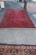 A ''Royal Heritage'' red and black rug in geometric design with eight lozenges, 118" x 79".