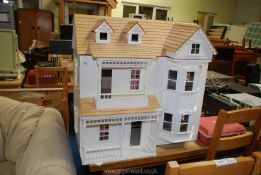 A large three storey open fronted dolls house, 32" x 31" x 19" (no furniture).