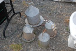 A quantity of galvanised poultry feeders and water drinkers with spare tops.