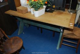 A bleached oak topped Tavern style table with rustic cross braced legs,