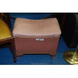 A Lloyd Loom style storage seat by Sirrom.