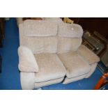 A two seater beige reclining sofa.