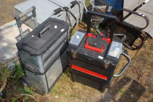 Two large wheeled tool boxes.