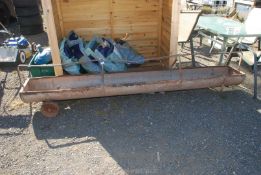 A sheep trough on wheels, 9ft long.