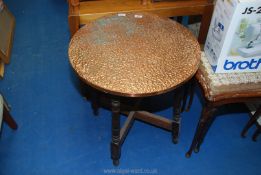 A hammered coppered round top table, 23 1/2'' diameter.