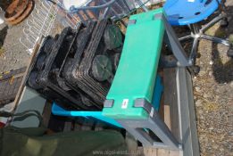 A box containing plastic flowerpot trays and Hozelock garden stool.