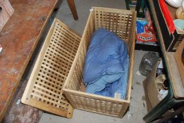An Ikea linen basket with an eiderdown quilt, 38½" x 19½" x 19½".