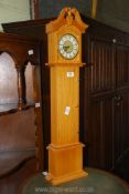 A miniature model clock in the form of a Grandfather clock (battery operated), 31 3/4'' high,