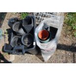 A bag and a large box of plastic pots and plant trays.