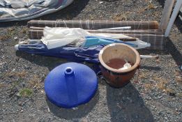 Blinds, parasols and parasol base and a planter.