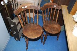 Two Welsh cottage kitchen chairs with circular elm seats.