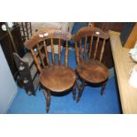 Two Welsh cottage kitchen chairs with circular elm seats.