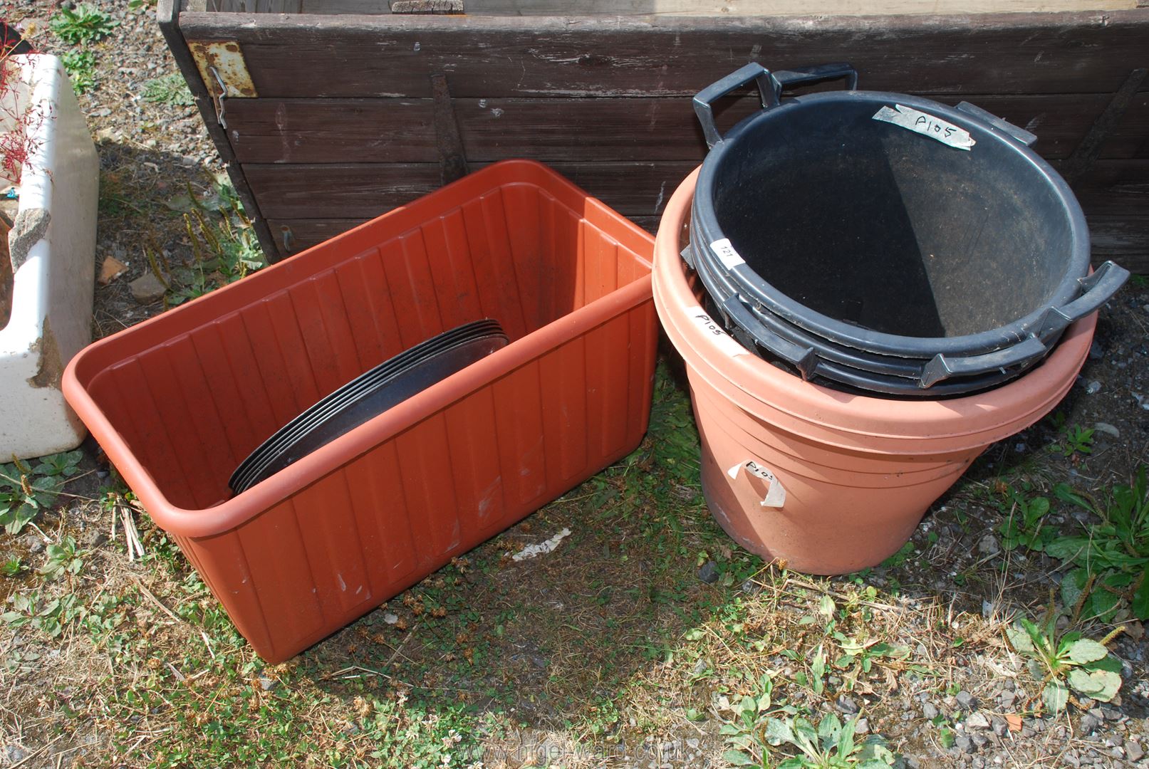 A quantity of large plastic pots and gravel trays.