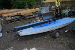 A blue 'Topper' sailing dingy with mast and hand trailer. Approximately 134" long x 46 1/2'' wide.