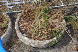 A large circular weathered concrete planter. 27" diameter.