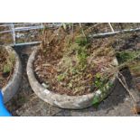 A large circular weathered concrete planter. 27" diameter.