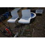 A pair of white plastic and chrome bar stools.