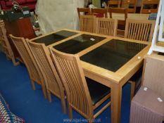 A table and four chairs, the table with granite effect ceramic inserts 35" x 29" x 71" long.