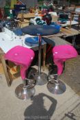 A bar table and pink bar stools with chrome bases, the glass top table 24" diameter x 42" high,