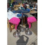 A bar table and pink bar stools with chrome bases, the glass top table 24" diameter x 42" high,