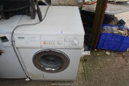 A Miele washing machine, (door handle a/f).
