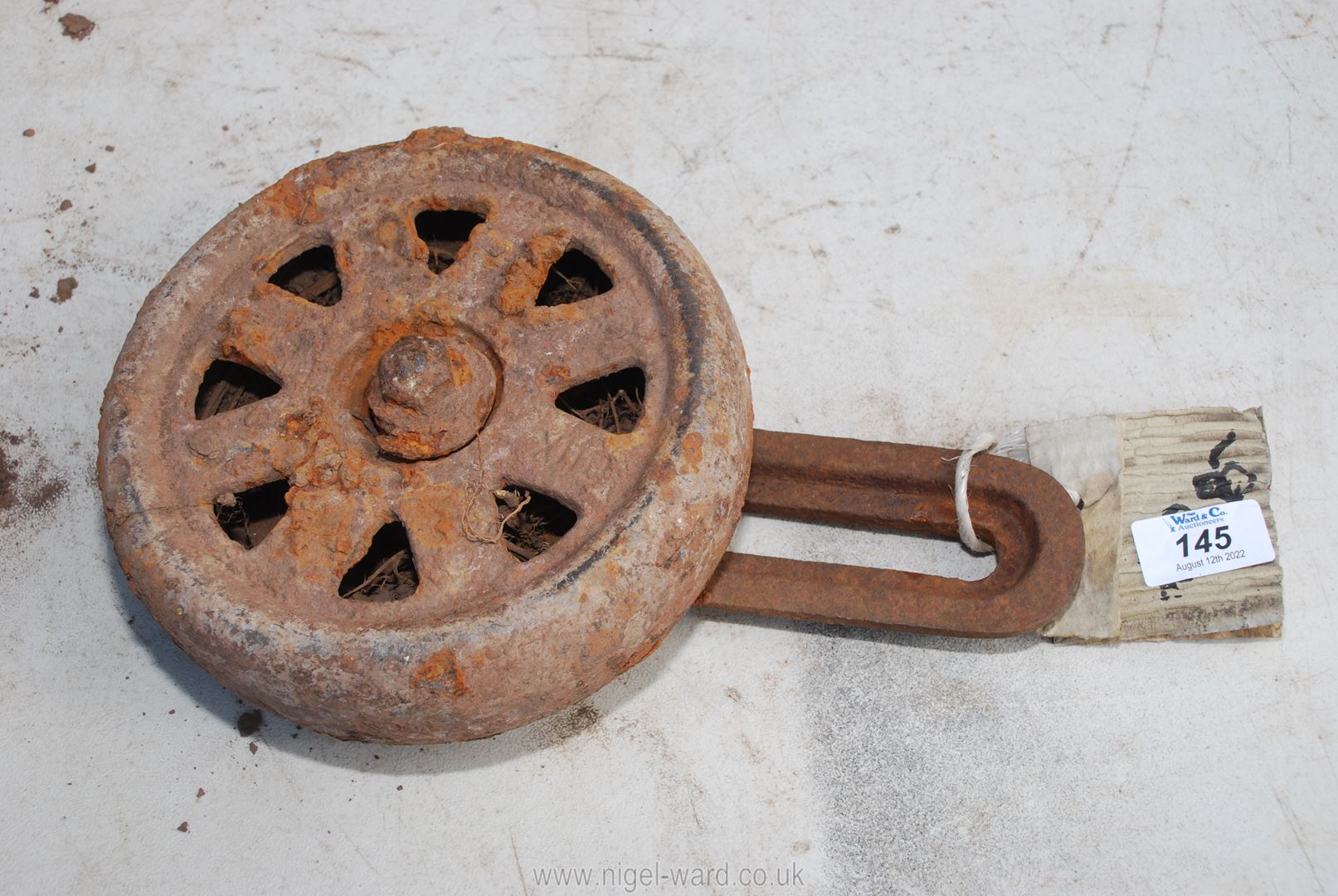 A small iron dolly wheel.