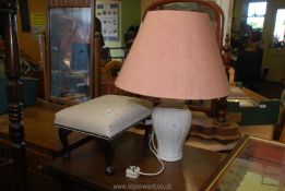 A china lamp and shade plus a small foot stool.