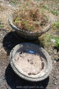 A round concrete planter 9" tall x 19" diameter and concrete bird bath top 16" diameter.