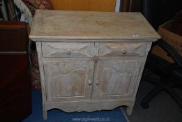 A rustic style limed wood cupboard with two drawers, 31" x 15" x 31".