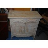 A rustic style limed wood cupboard with two drawers, 31" x 15" x 31".