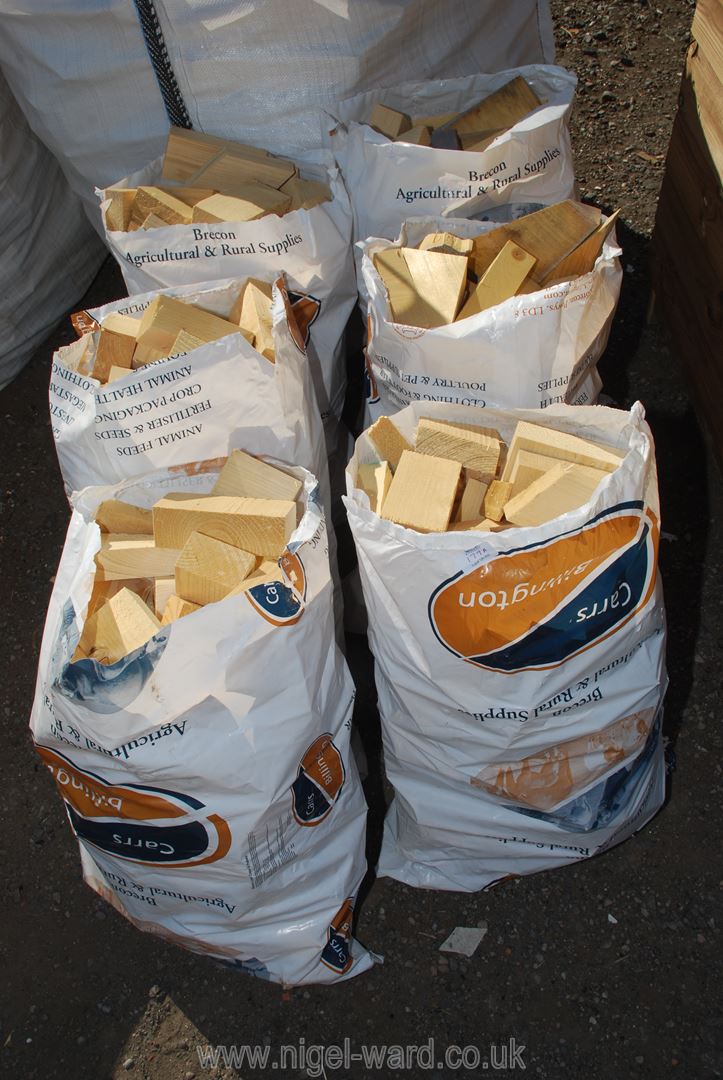 Six bags of small softwood logs.
