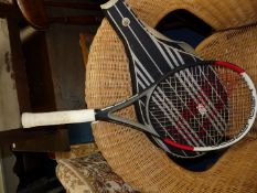 A Slazenger pro tennis racquet in striped cover.