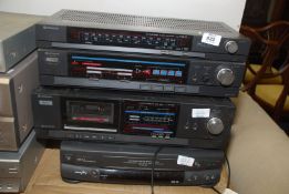 A Hitachi radio tuner and tape player, with a Goodmans VHS player a/f. Sold As Seen.