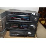 A Hitachi radio tuner and tape player, with a Goodmans VHS player a/f. Sold As Seen.