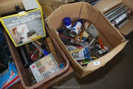 A box of decorating equipment and tools.