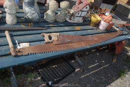 A two man wood saw and vintage hand saw.