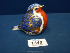 A Royal Crown Derby paperweight in the form of a robin having a colourful blue coat and red breast,