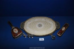 A dressing table set comprising lace decorated tray, clothes brush and hair brush,
