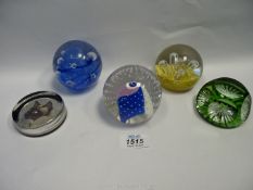Five paperweights including Caithness 'Moonflower' paperweight.