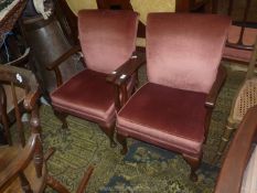 A pair of Parker Knoll style low open-armed Chairs for re-upholstery.