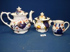 Three pieces of Gaudy china to include teapot, small lidded tureen and small jug.
