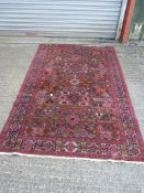 A hand woven Eastern rug with symbols and geometric pattern, 55'' wide x 85'' long.