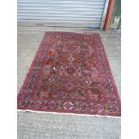 A hand woven Eastern rug with symbols and geometric pattern, 55'' wide x 85'' long.