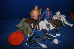 Two Action Man dolls with clothing, knitted cardigan, army jacket, guns, boots, snow shoes, etc.