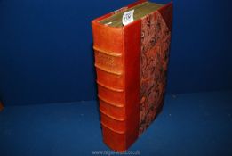 A red leather bound copy of 'The Great Historical, Geographical,