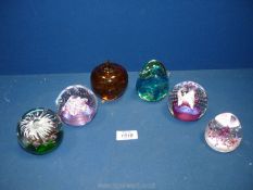 Six glass paperweights including two Caithness, Mdina glass bird paperweight, apple paperweight,